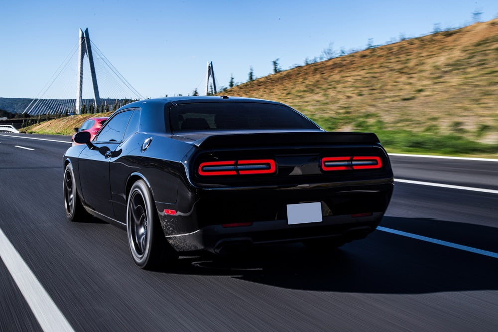 black sport coupe driving with back red lights